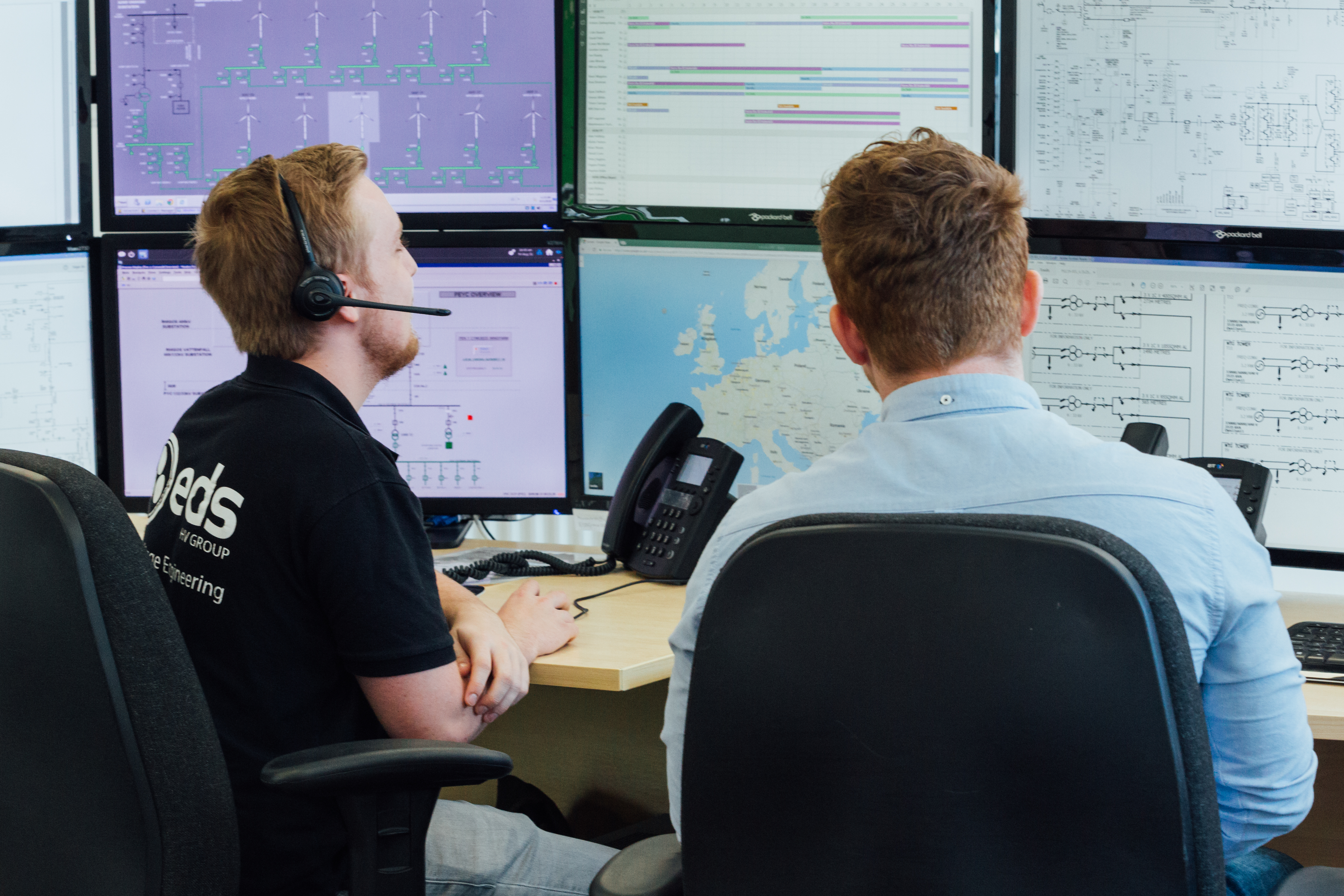 EDS employees looking at computer monitors