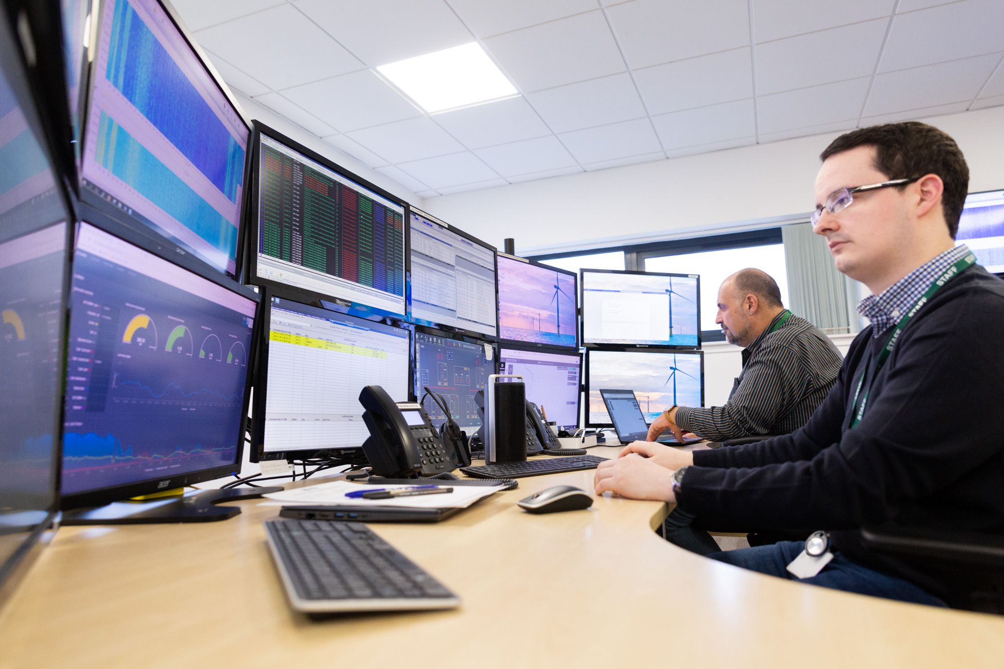 EDS employee looking at computer monitors